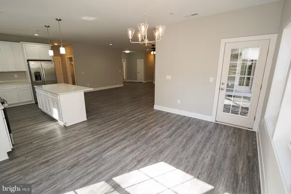 an empty room with a window and a ceiling fan