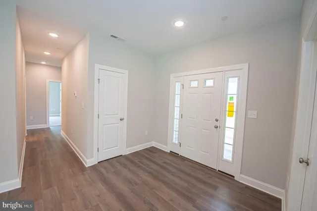 a view of a hallway with wooden floor