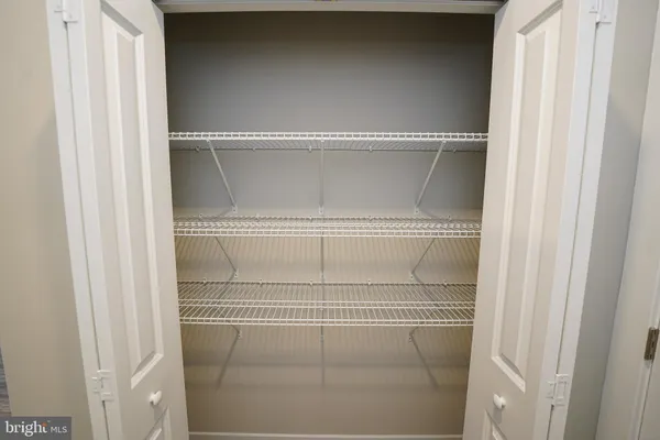 a view of a room with a ceiling fan and a window