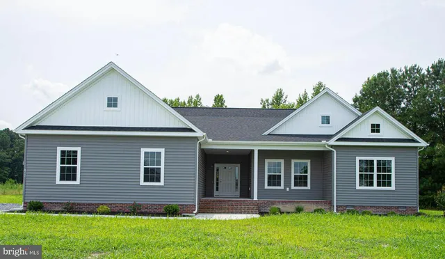 front view of brick house with a yard
