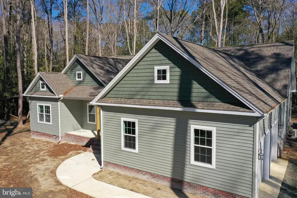 a kitchen with stainless steel appliances a refrigerator a sink dishwasher a stove top oven a refrigerator and cabinets with wooden floor