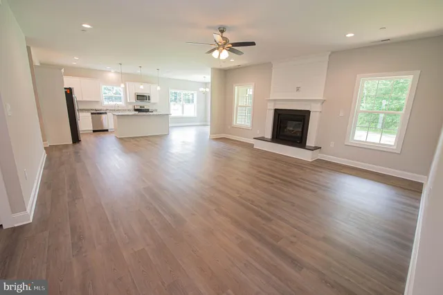 a view of a kitchen with a sink a fireplace and a window