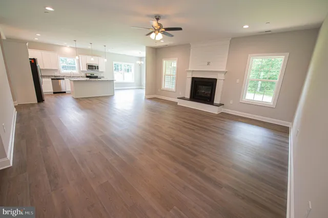 an open kitchen with a sink a refrigerator and a fireplace