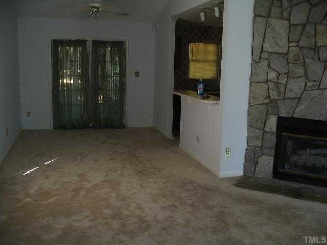 2221 Carthage Circle Raleigh, NC 27604 - Photo 2 of 6 an empty room with windows and cabinet