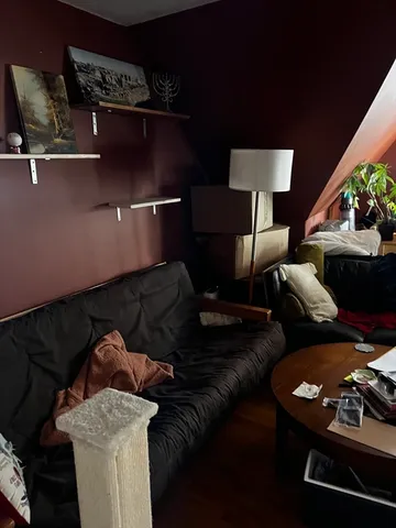 a living room with furniture and a lamp