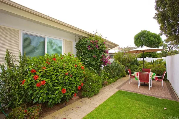 a view of a house with backyard sitting area and garden