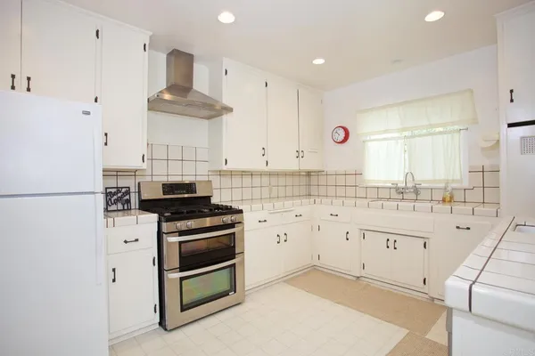 a kitchen with stainless steel appliances a stove a sink and a refrigerator