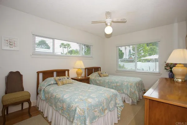 a bedroom with two beds and a window