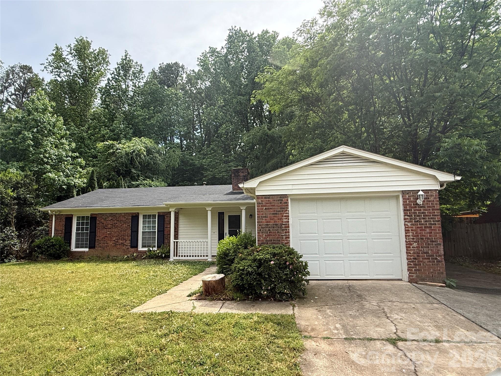 6341 Round Hill Road Charlotte, NC 28211 - Photo 1 of 16 a front view of a house with a yard