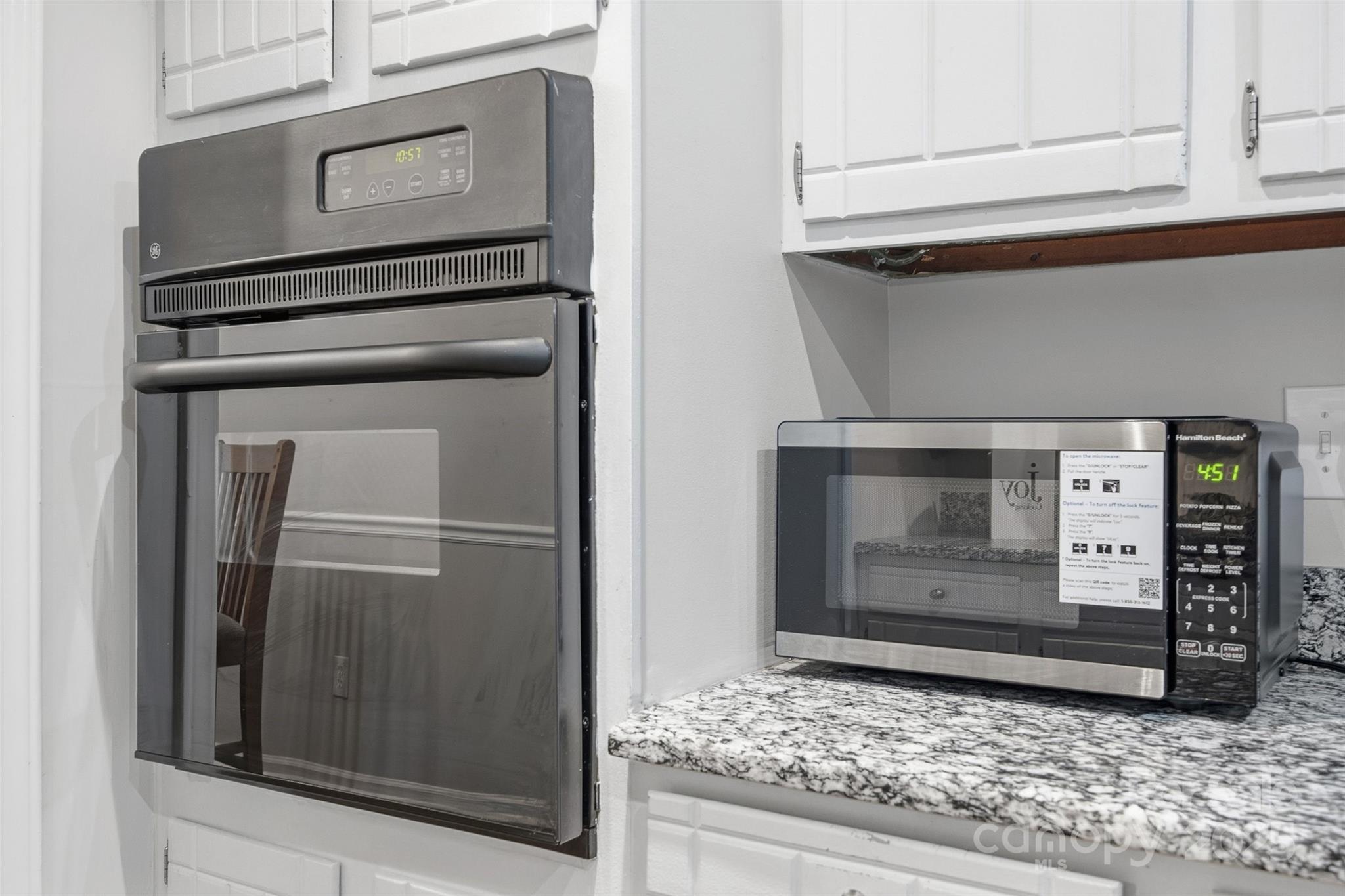 4739 Hedgemore Drive, Unit O Charlotte, NC 28209 - Photo 13 of 25 a stove top oven sitting inside of a kitchen