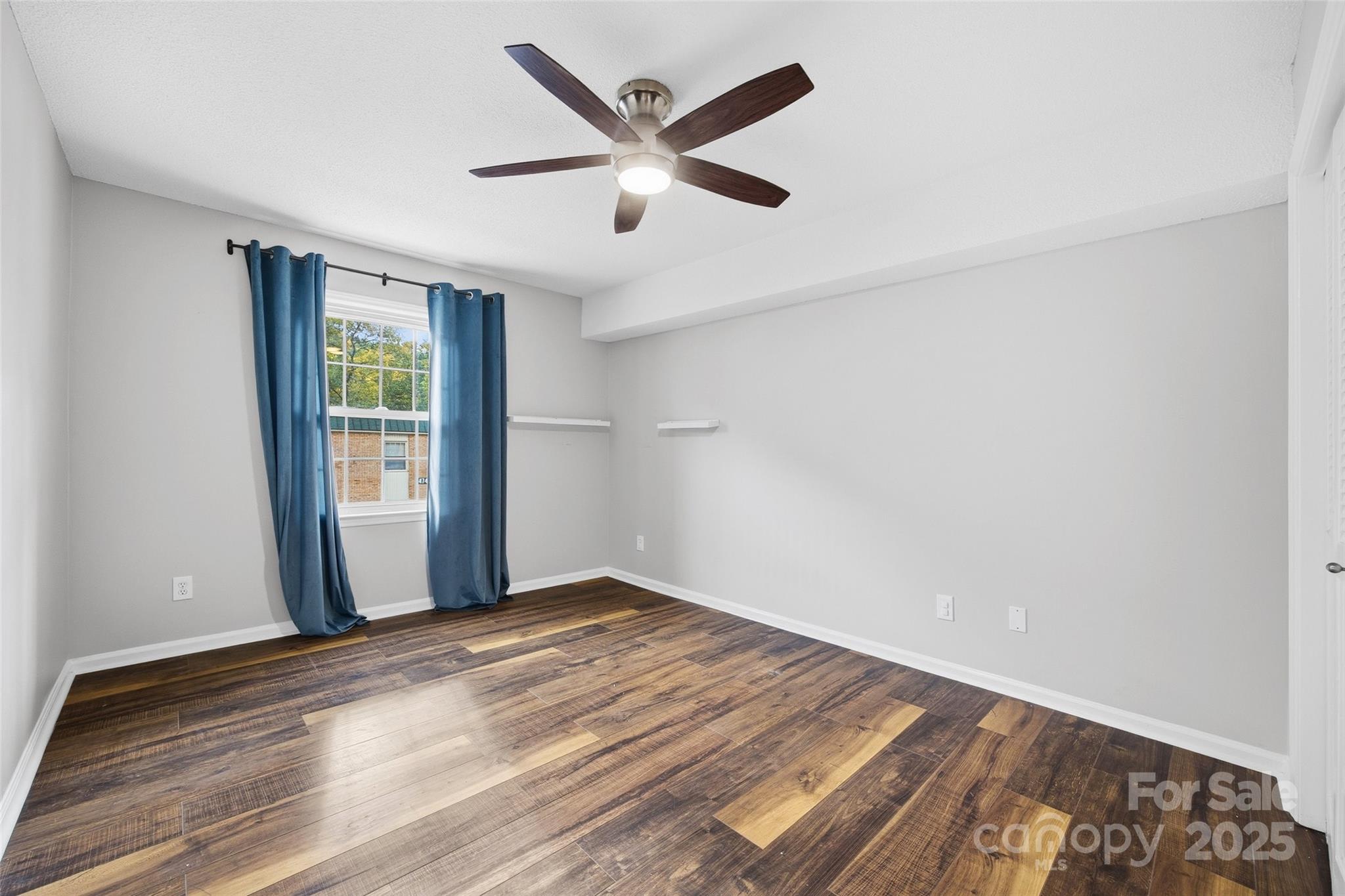 4739 Hedgemore Drive, Unit O Charlotte, NC 28209 - Photo 14 of 25 wooden floor in an empty room with a window
