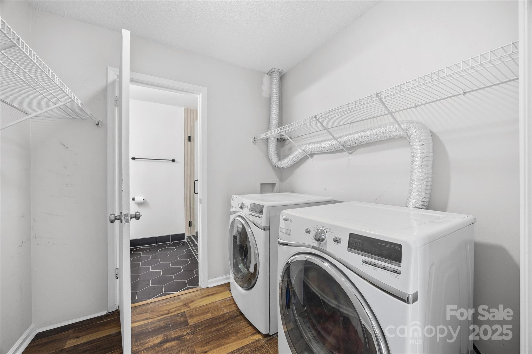 4739 Hedgemore Drive, Unit O Charlotte, NC 28209 - Photo 18 of 25 a view of storage and utility room with washer and dryer