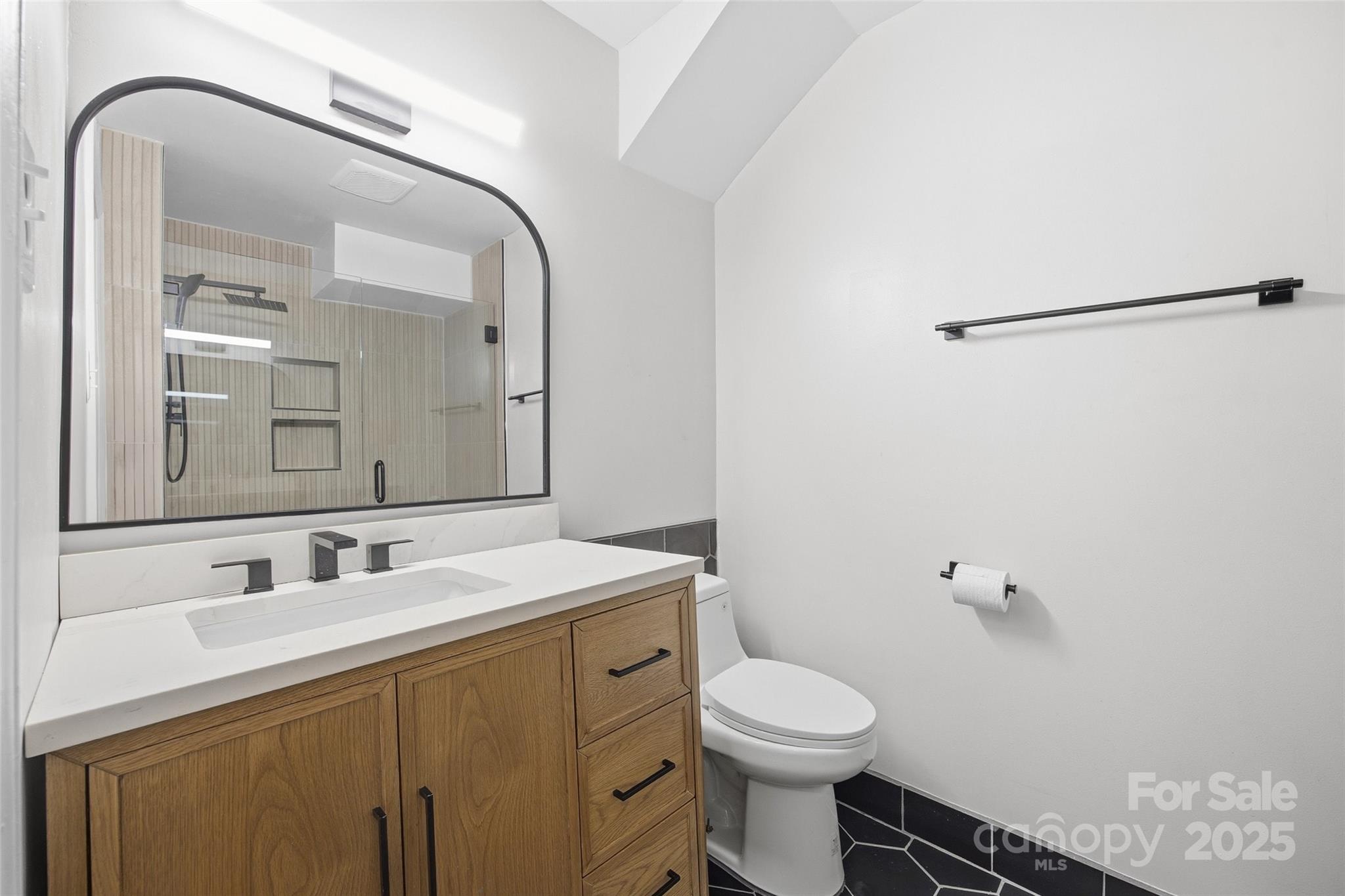 4739 Hedgemore Drive, Unit O Charlotte, NC 28209 - Photo 19 of 25 a bathroom with a sink toilet and a mirror