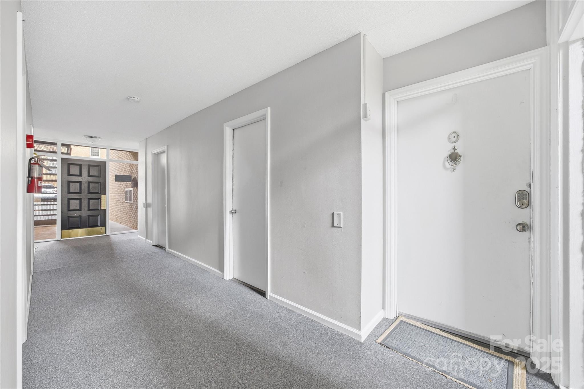 4739 Hedgemore Drive, Unit O Charlotte, NC 28209 - Photo 2 of 25 a view of a closet area with an empty room