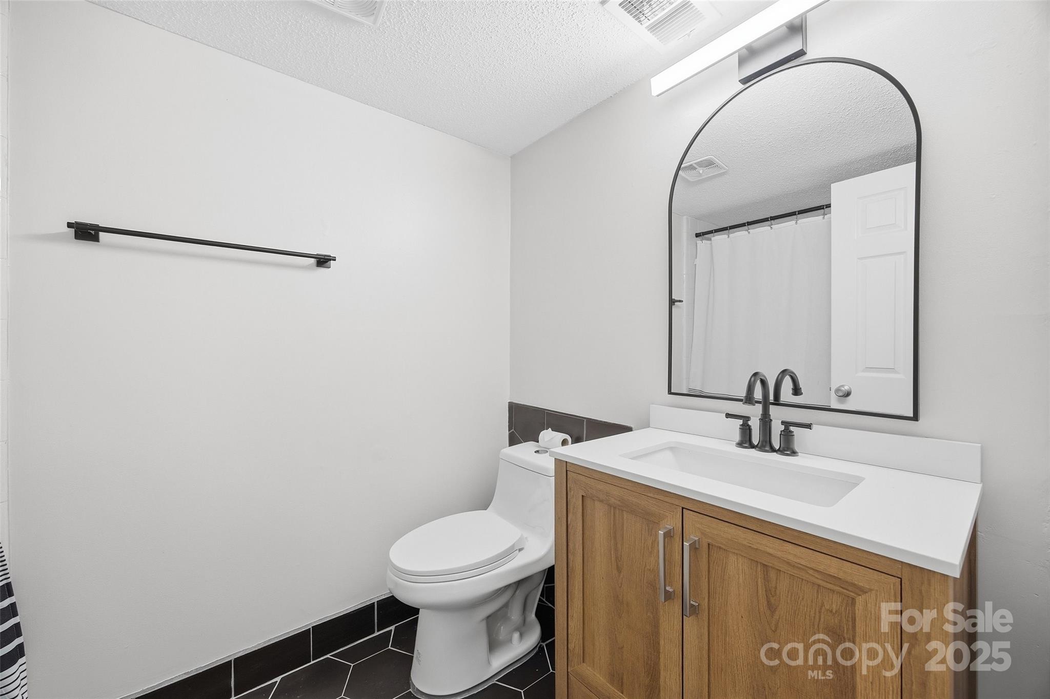 4739 Hedgemore Drive, Unit O Charlotte, NC 28209 - Photo 21 of 25 a bathroom with a sink and a mirror