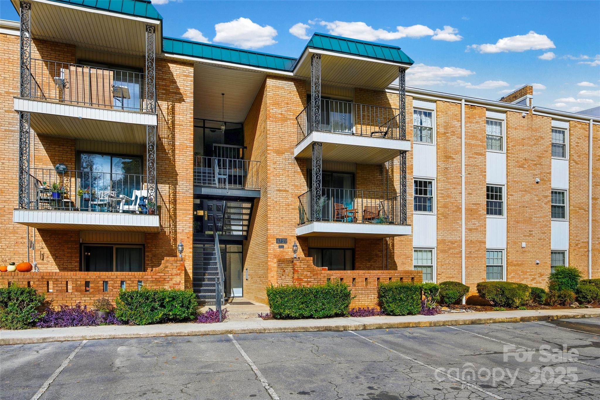 4739 Hedgemore Drive, Unit O Charlotte, NC 28209 - Photo 23 of 25 a front view of a house with a yard