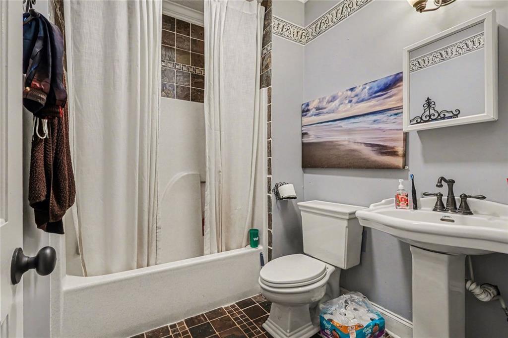 1940 Honey Creek Road Southwest Conyers, GA 30094 - Photo 15 of 31 a bathroom with a toilet sink and mirror
