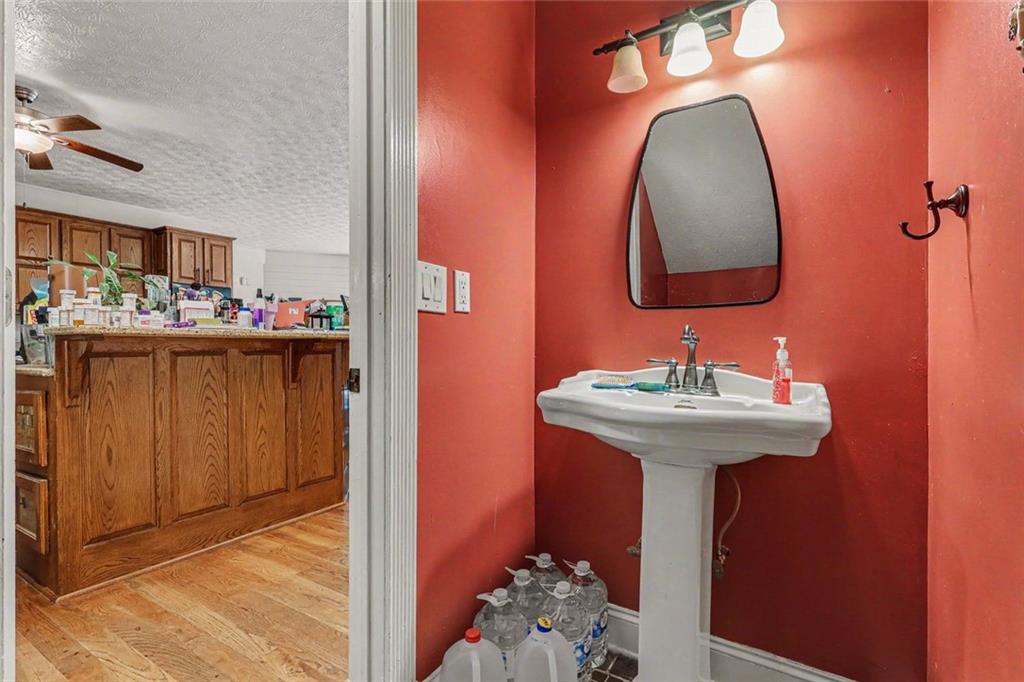 1940 Honey Creek Road Southwest Conyers, GA 30094 - Photo 16 of 31 a bathroom with a sink and a mirror