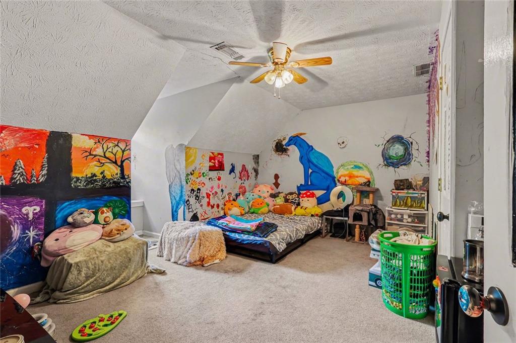 1940 Honey Creek Road Southwest Conyers, GA 30094 - Photo 18 of 31 a children room with toys and a fan