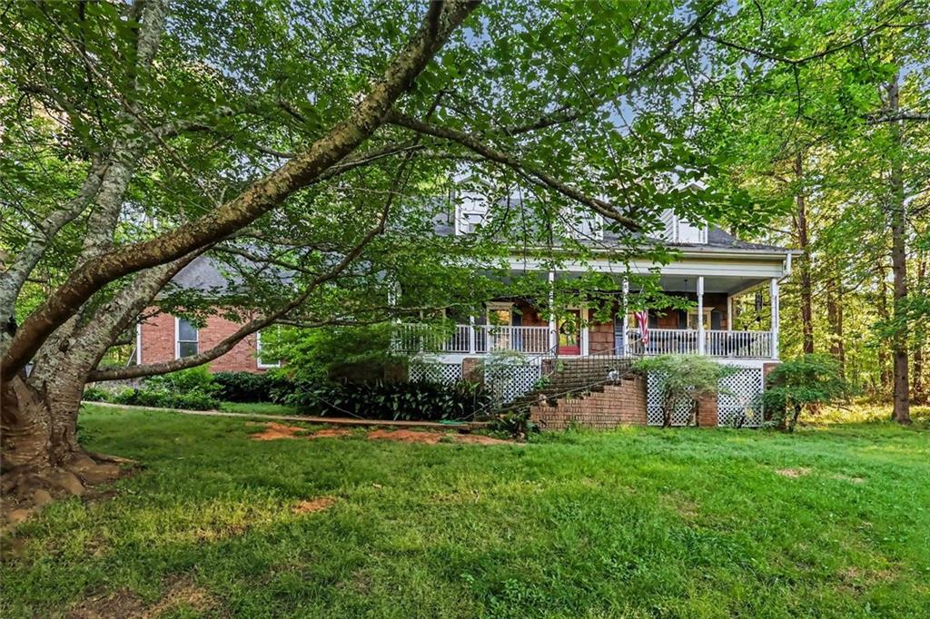 1940 Honey Creek Road Southwest Conyers, GA 30094 - Photo 27 of 31 a front view of a house with garden