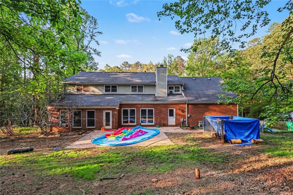 1940 Honey Creek Road Southwest Conyers, GA 30094 - Photo 29 of 31 a view of the house with swimming pool and sitting area
