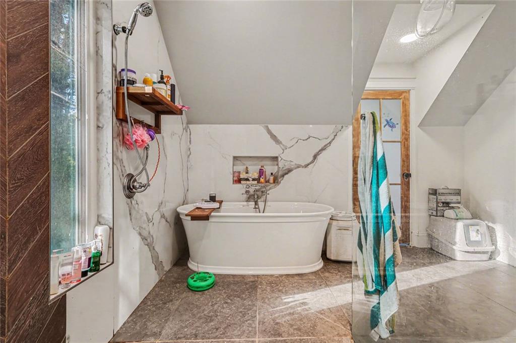 1940 Honey Creek Road Southwest Conyers, GA 30094 - Photo 7 of 31 a bathroom with a sink and a shower