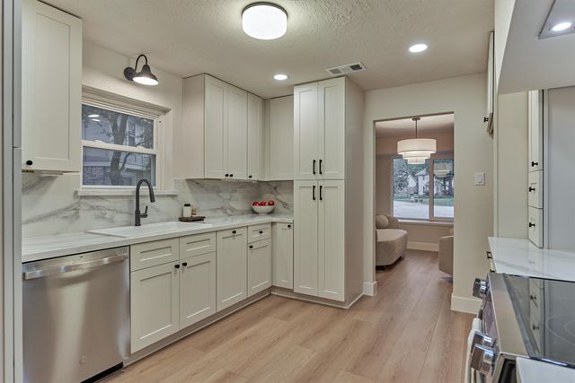 a living room with furniture and a ceiling fan
