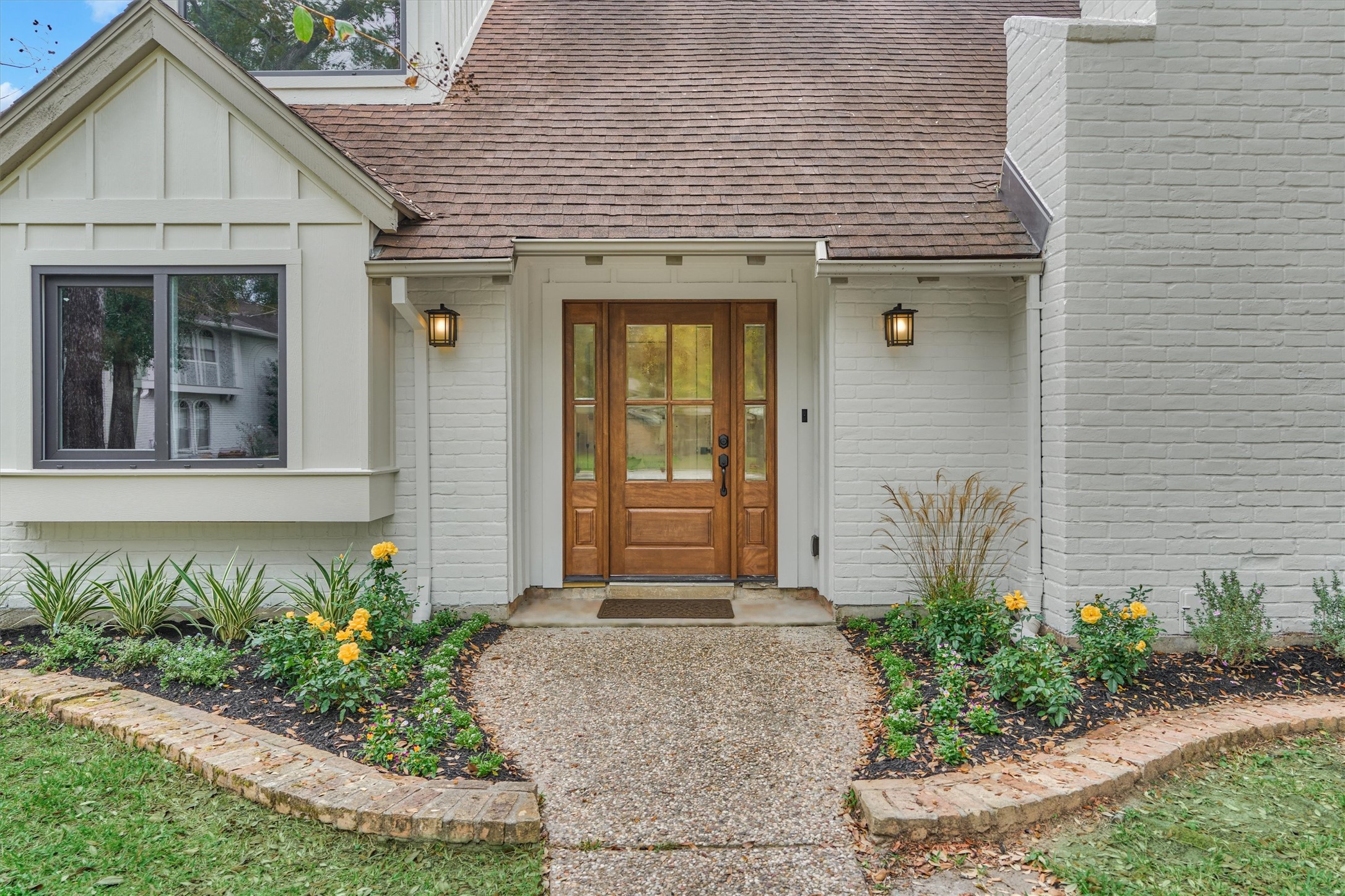 27286 Jimmy Lane Conroe, TX 77385 - Photo 4 of 50 Charming front walk-up to the trendy white brick exterior with fresh landscaping.