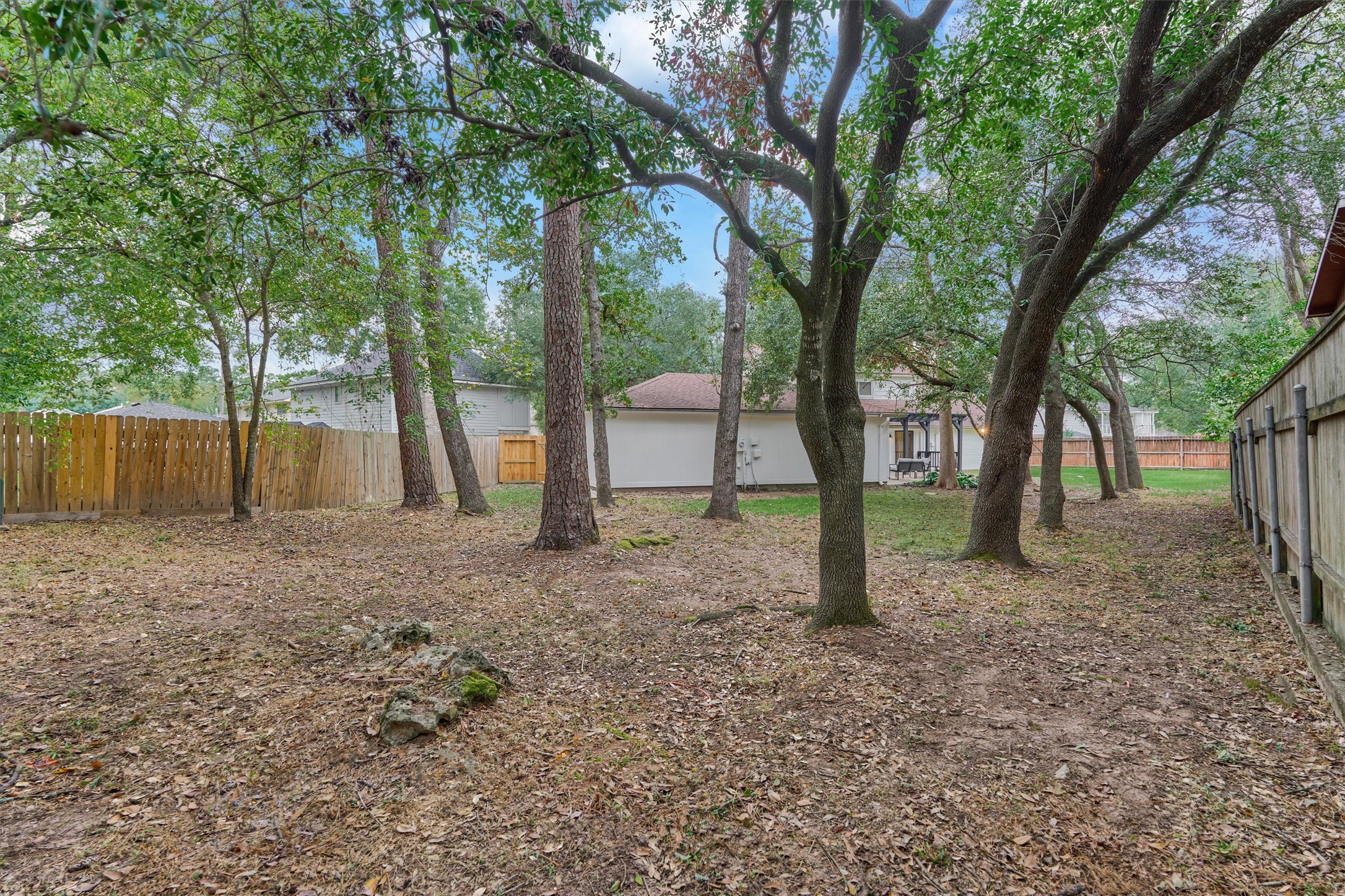 27286 Jimmy Lane Conroe, TX 77385 - Photo 43 of 50 You'll never tire of your spacious backyard with tall, mature trees.