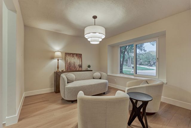 a living room with furniture and a large mirror