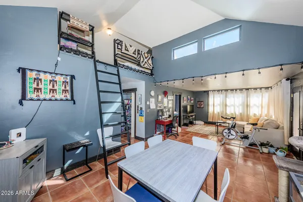 a living room with furniture a rug and a large window