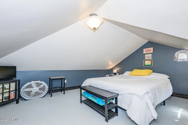 a bedroom with a bed and a night stand