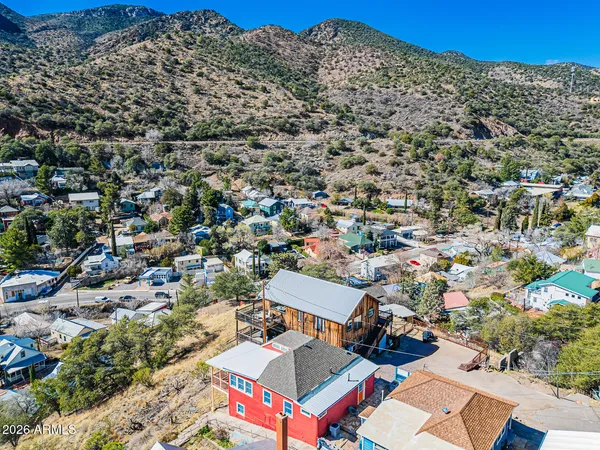an aerial view of residential houses with outdoor space and street view