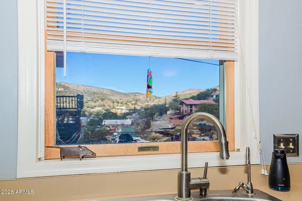 a view of a livingroom with workspace and a window