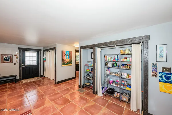 a living room with furniture and a book shelf