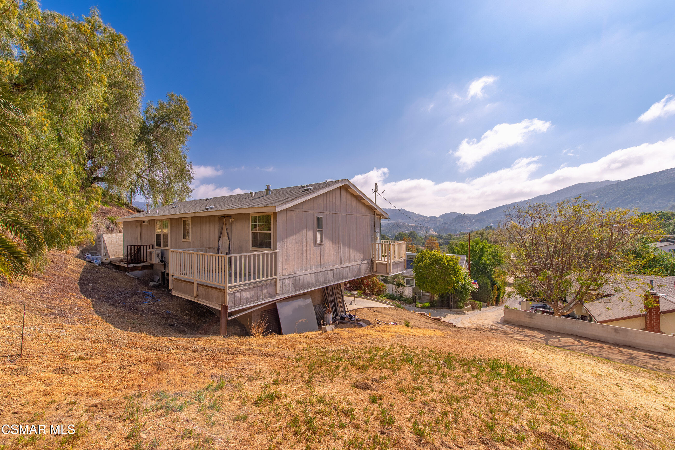 6079 Cedar Street Simi Valley, CA 93063 - Photo 30 of 31 a wooden house with a large tree in front of it