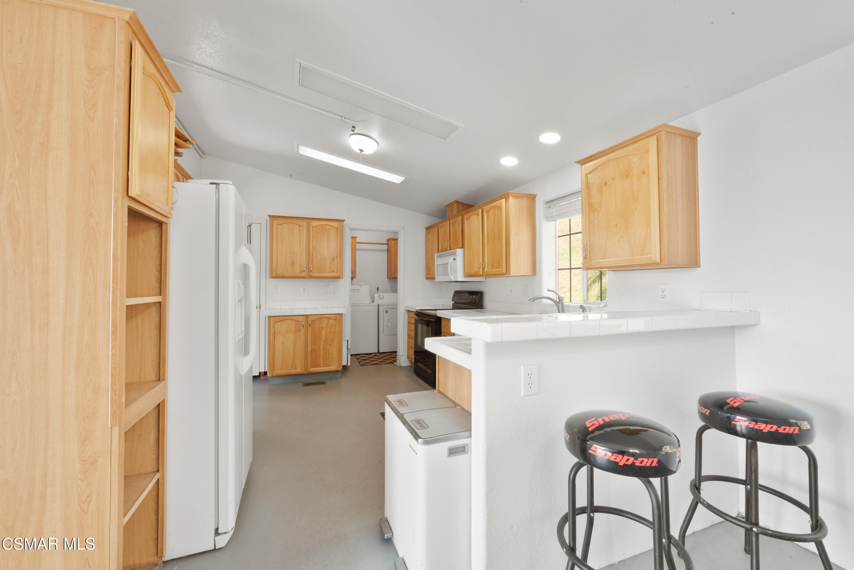 6079 Cedar Street Simi Valley, CA 93063 - Photo 6 of 31 a kitchen with stainless steel appliances kitchen island granite countertop a refrigerator and a stove top oven
