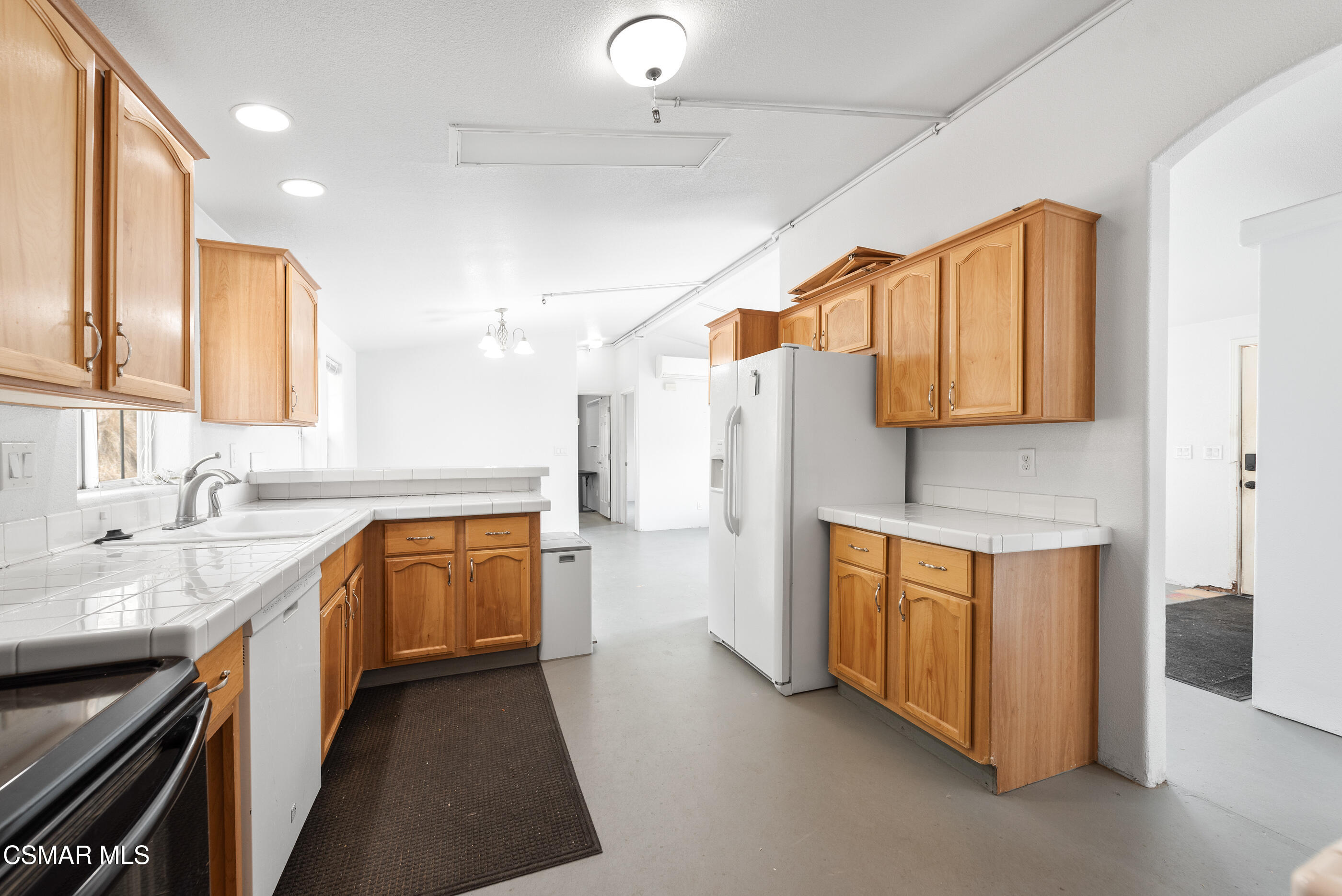 6079 Cedar Street Simi Valley, CA 93063 - Photo 9 of 31 a kitchen with stainless steel appliances granite countertop a sink a stove and a refrigerator