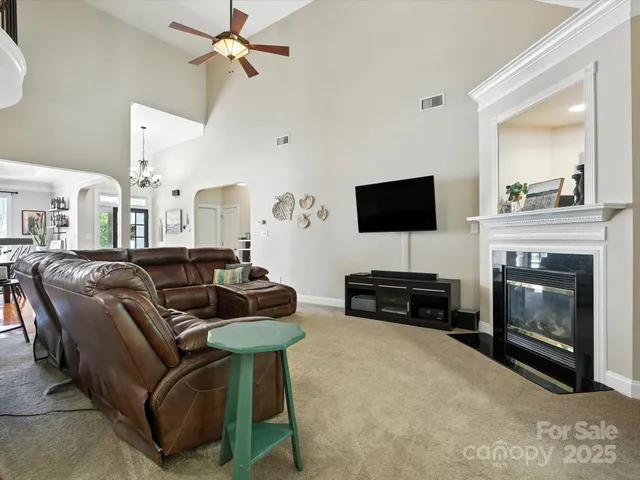 a living room with furniture large window and fireplace