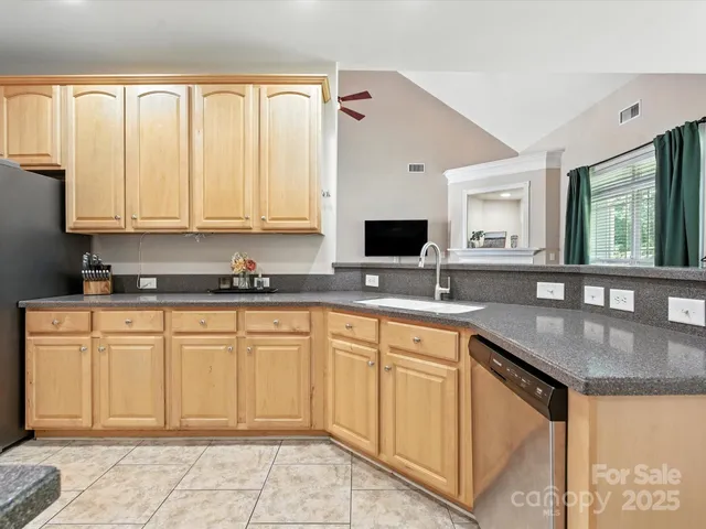 a kitchen with stainless steel appliances granite countertop a sink and cabinets