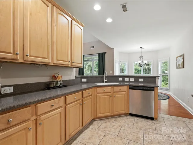 a kitchen with stainless steel appliances a stove microwave and sink
