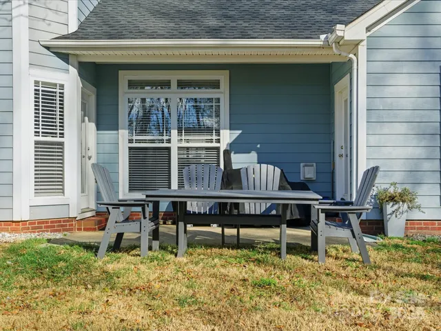 an aerial view of a house with a yard and lake view