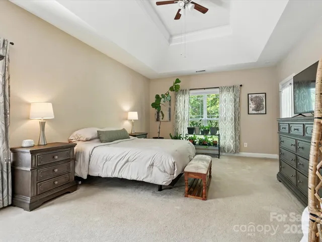 a spacious bedroom with a bed and a table in it