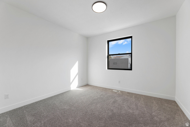14392 South Champ Cove Draper, UT 84020 - Photo 19 of 31 Spare room featuring carpet floors and baseboards