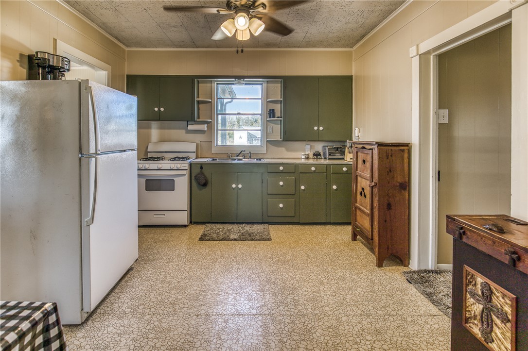 9354 Farm To Market 2780 Burton, TX 77835 - Photo 12 of 43 a kitchen with stainless steel appliances a refrigerator sink and stove