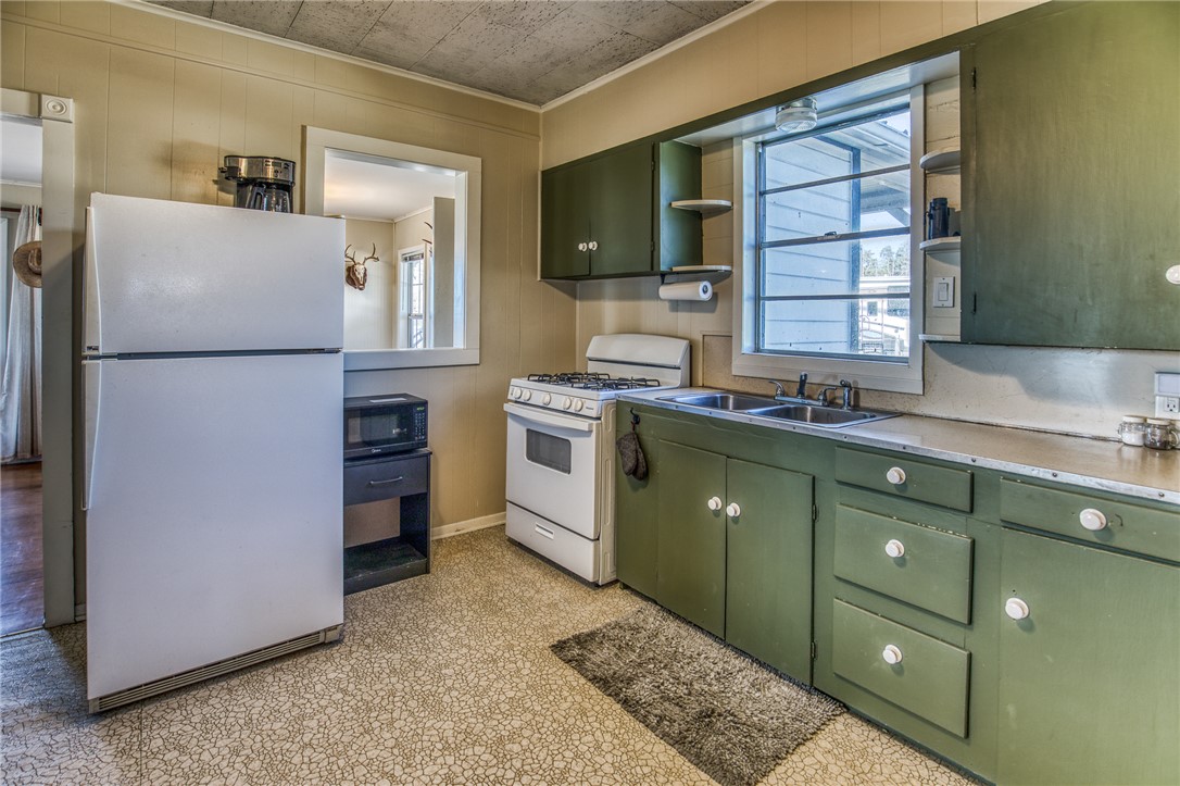 9354 Farm To Market 2780 Burton, TX 77835 - Photo 13 of 43 a kitchen with a refrigerator and a sink
