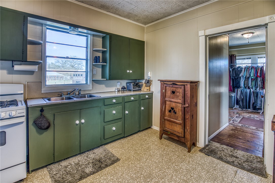 9354 Farm To Market 2780 Burton, TX 77835 - Photo 14 of 43 a kitchen with a refrigerator sink and cabinets