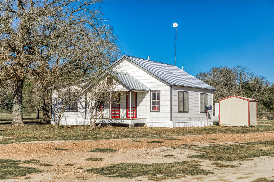 9354 Farm To Market 2780 Burton, TX 77835 - Photo 5 of 43 a front view of a house with a yard