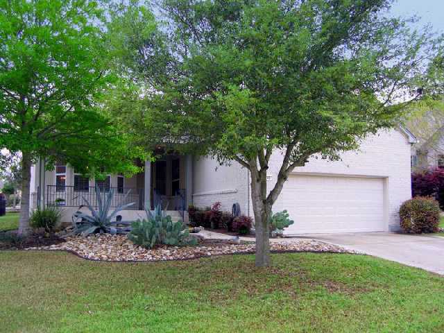 145 Trail Rider Way Georgetown, TX 78633 - Photo 1 of 1 a front view of a house with a garden and tree