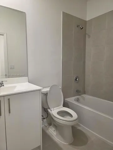 a bathroom with a toilet a sink and a bathtub